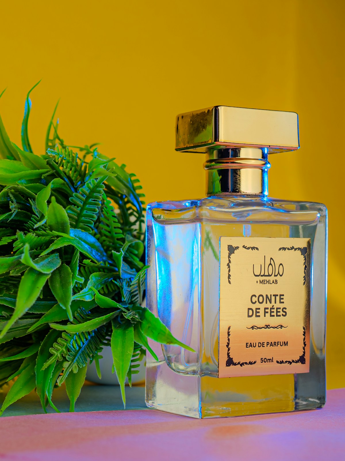 Perfume bottle beside a potted plant