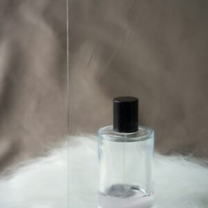 Clear glass perfume bottle with black cap